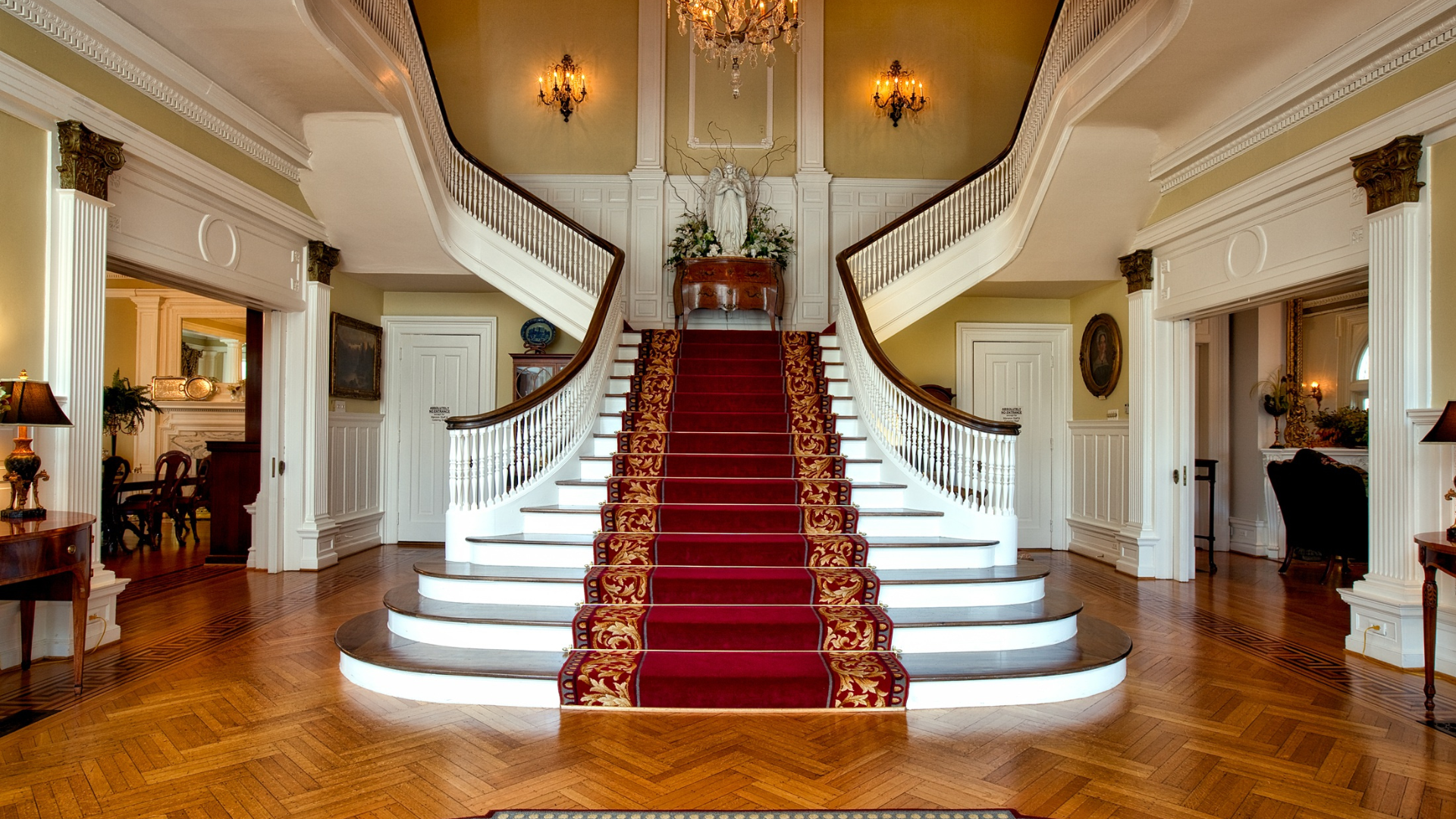 Owning the Best House in the Neighborhood - Foyer with grand staircase with carpeted runner